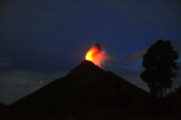 night view of volcan del fuego spitting out fire