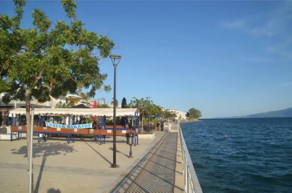 Waterfront promenade and seaside cafés in Amarynthos, Euboea, Greece.