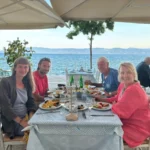 Outdoor waterfront restaurant in Amarynthos, Euboea, Greece, overlooking the South Euboean Gulf.