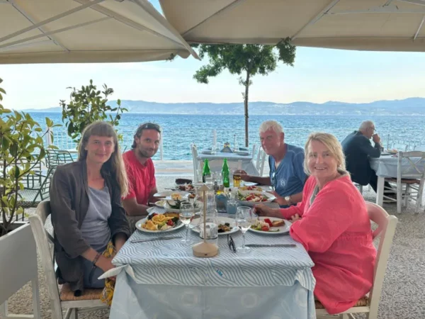 Outdoor waterfront restaurant in Amarynthos, Euboea, Greece, overlooking the South Euboean Gulf.