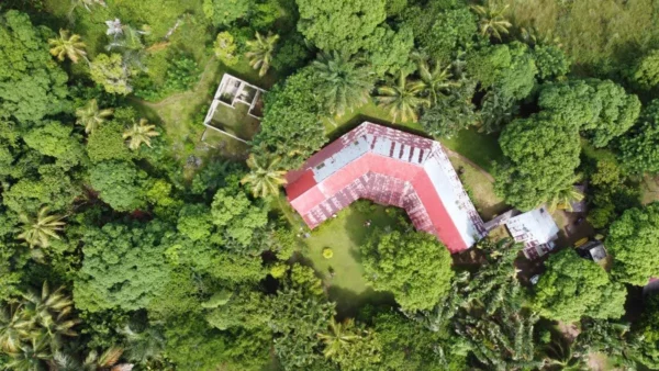 Bird's-eye view of Villa Les Orchidées surrounded by lush tropical gardens in Belle Vue, Sainte Marie Island, Madagascar.