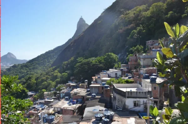 Christ the redeemer looming over the favela santa marta in rio