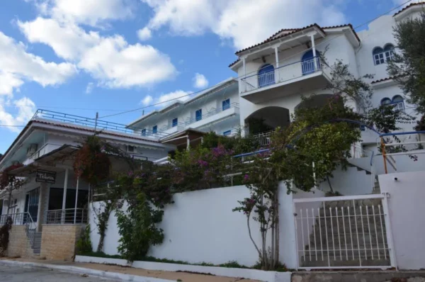 Cute wide beachfront properties with blue shutters in the euboean village of kalamos