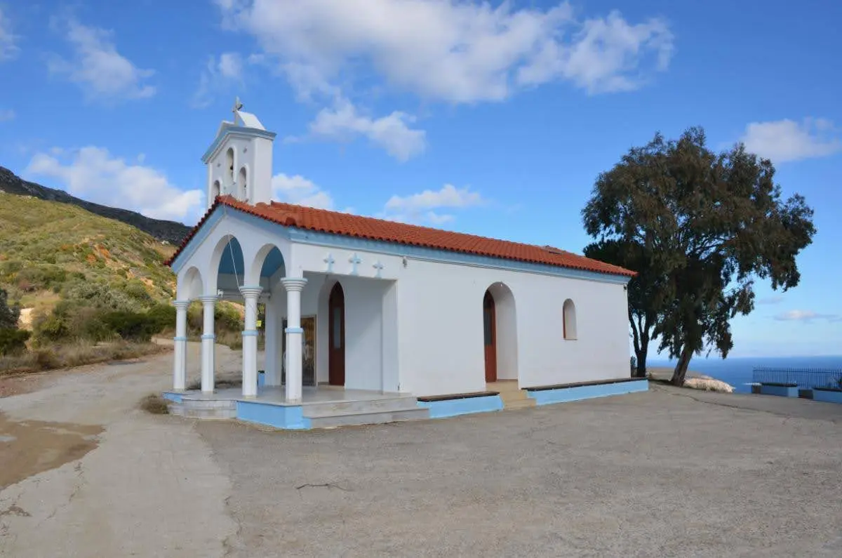 The blue-white church of Agios Georgios overlooking Korasida beach in evia island in greece