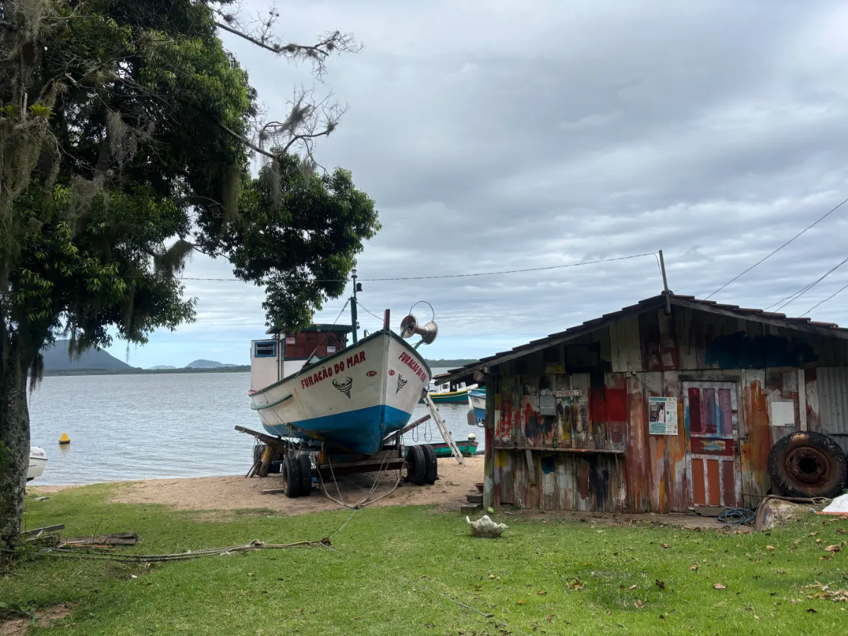 Traditional beachfront property and boat on the shore of lagoa da conceicao