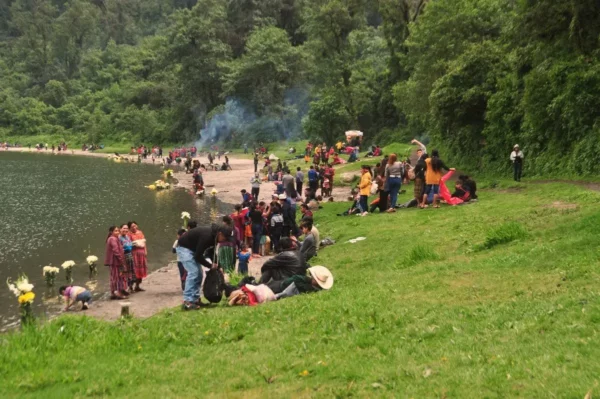 maya people carrying out rituals All along the lakeshore of lake chicabal in guatemala