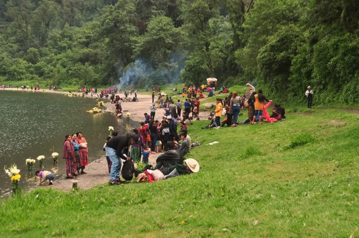 maya people carrying out rituals All along the lakeshore of lake chicabal in guatemala