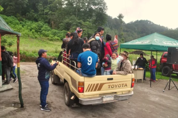 pickup truck with rear filled with passengers at laguna chicabal entrance area in guatemala