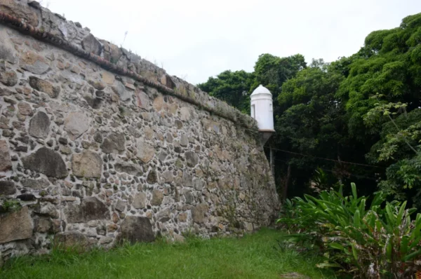 White bartizan at a corner of thick stone wall of fotaleza de sao jose in florianopolis