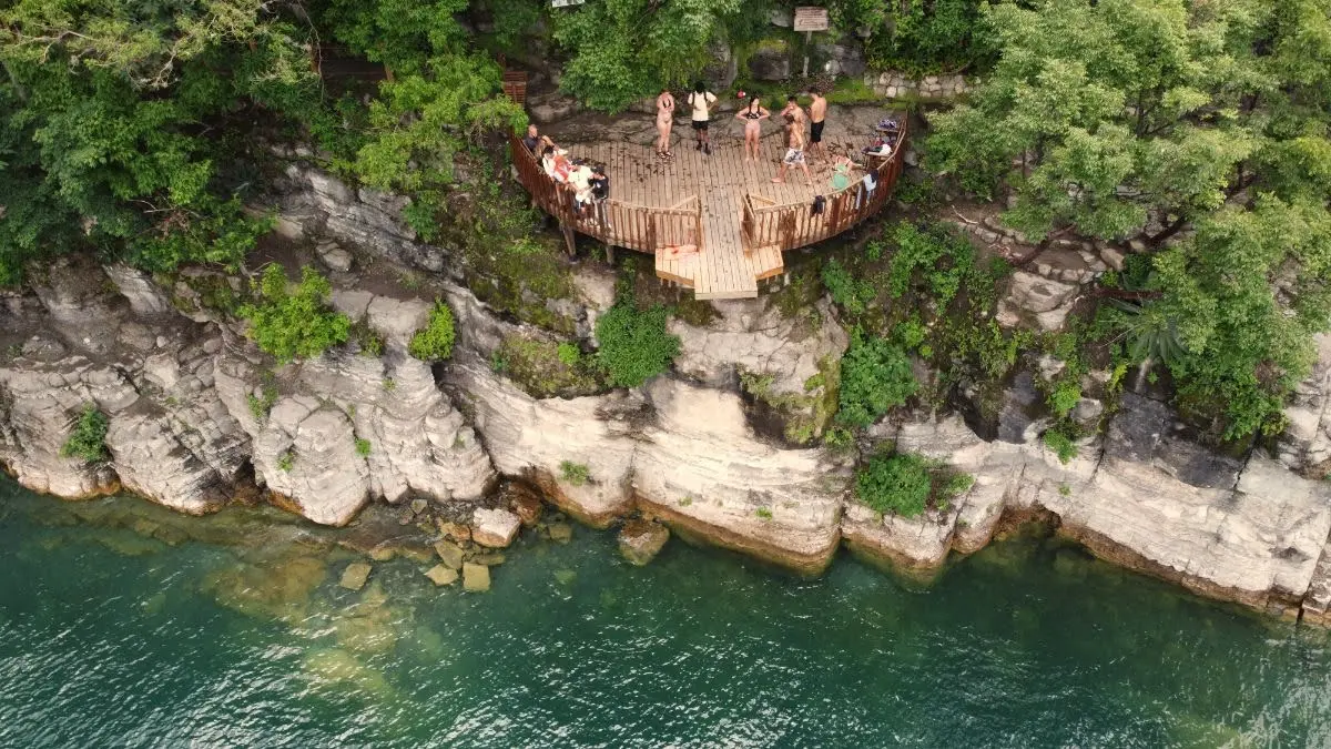 The cliff jumping platform at san marcos, lake atitlan, viewed from above through drone