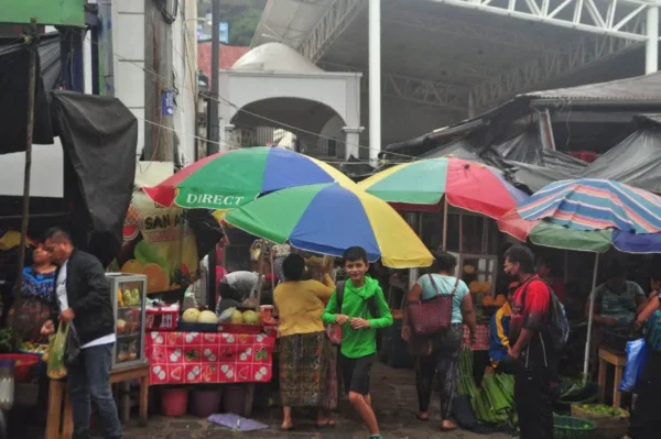 Colorful umbrellas and vendors at the San Pedro La Laguna market on Lake Atitlán