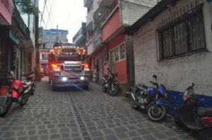 Chicken bus maneuvering through the streets of San Pedro La Laguna on shore of lake atitlan