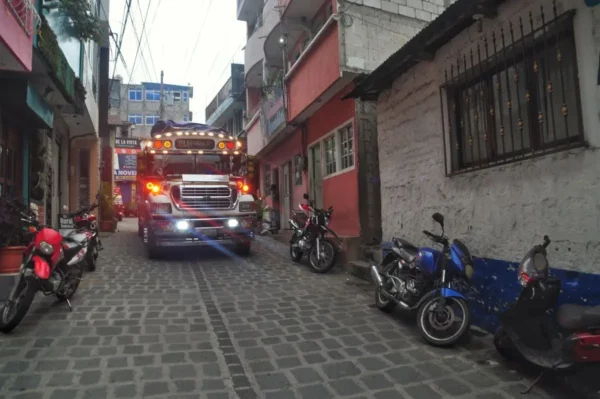 Chicken bus maneuvering through the streets of San Pedro La Laguna on shore of lake atitlan