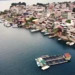 Aerial view of San Pedro La Laguna on Lake Atitlán, with hillside houses and boats along the waterfront