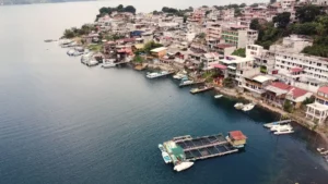 Aerial view of San Pedro La Laguna on Lake Atitlán, with hillside houses and boats along the waterfront
