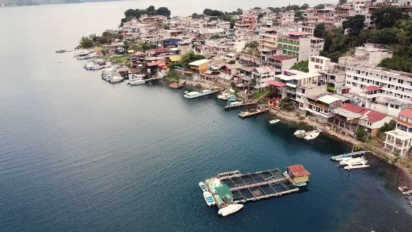 Aerial view of San Pedro La Laguna on Lake Atitlán, with hillside houses and boats along the waterfront