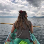 kayaking in lake atitlan under a cloudy sky