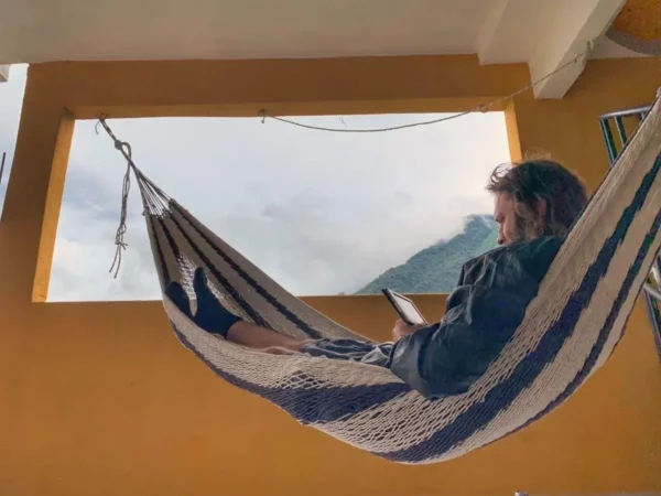 Man reading in a hammock on terrace of hotel peneleu in san pedro la laguna, lake atitlan