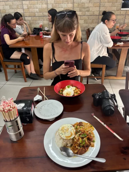 eating asian food in liberdade, the japanese town of sao paulo