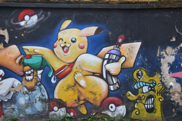 mural of Picachu holding a graffiti spray in liberdade japantown of sao paulo
