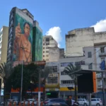 Native American giving a thumbs-up in one of many building-sized murals of São Paulo