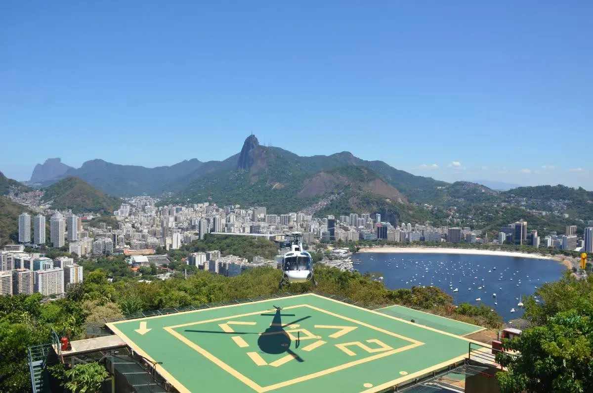 Helicopter returning from a ride to Christ the Redeemer from helipad atop morro da urca in rio de janeiro