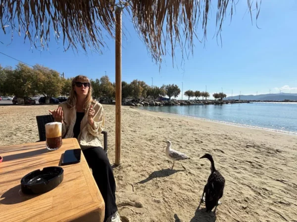 Drinking a coffee at greek beach surrounded by ducks and seagulls