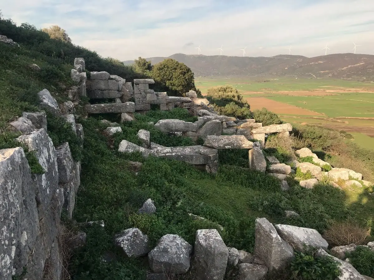 Remntants of erstwhile houses overlooking plains of south evia from ancient dystos hilltop
