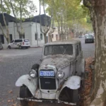 vintage car in cobbled street with fallen autumn leaves in colonia del sacramento, uruguay