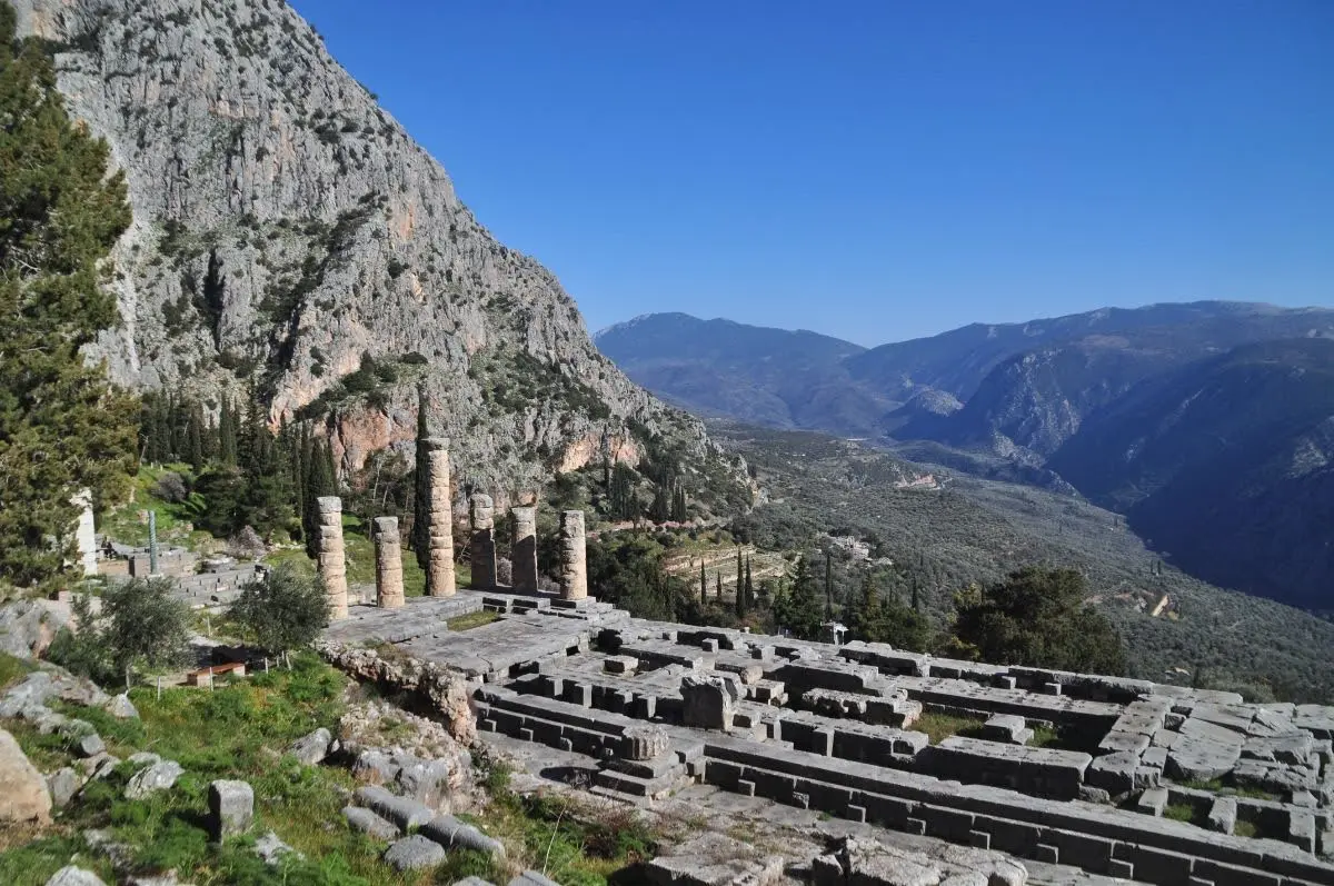 The Temple of Apollo at Delphi and the secluded valley on the slopes of mount parnassos