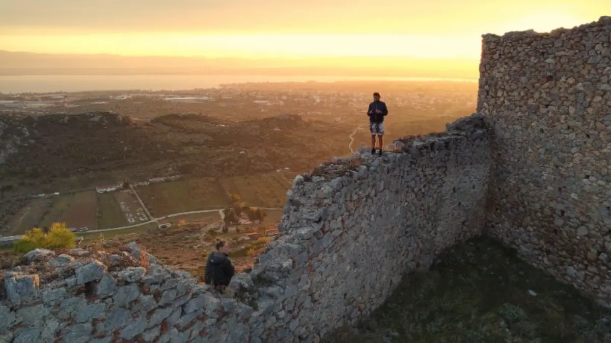 Enjoying a fiery sunset from atop the walls of the castle of fylla in central evia island