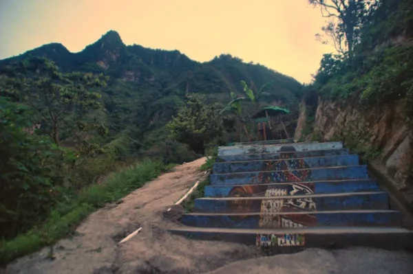 Indian Nose towering above the first part of trail with mural-covered steps at lake atitlan