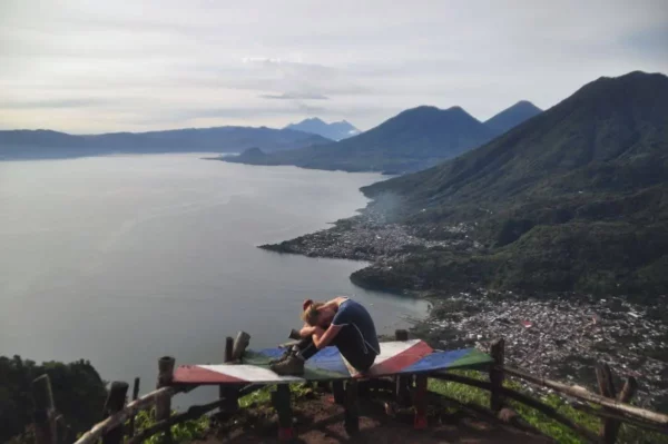 Stunning view of Lake Atitlán from Indian Nose, featuring expansive water, surrounding mountains, and a serene landscape in Guatemala.