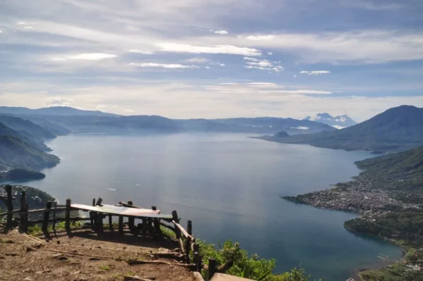 Breathtaking view of Lake Atitlán from Indian Nose, featuring serene waters, distant mountains, and lush greenery.