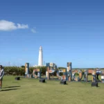 Name sign and the lighthouse of La Paloma