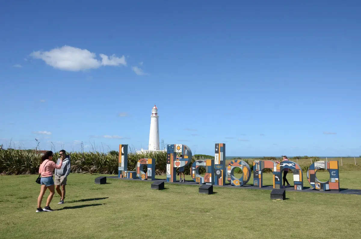 Name sign and the lighthouse of La Paloma