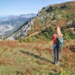 Hiker overlooking the dramatic cliffs and mountain ridges of Mount Dirfys in Central Evia, Greece