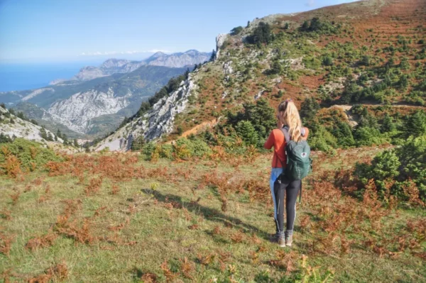 Hiker overlooking the dramatic cliffs and mountain ridges of Mount Dirfys in Central Evia, Greece