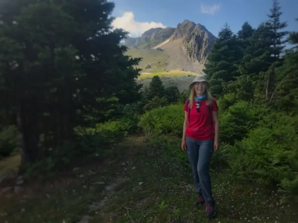 Hiking through lush greenery with Mount Xerovouni rising in the background on Euboea, Greece, creates a stunning natural scene.