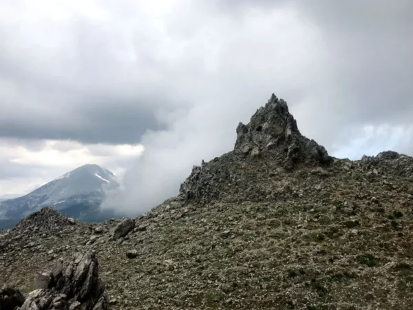 Stunning rocky summit at Mount Xerovouni, with dramatic cloudy skies and rugged terrain in Euboea, Greece.