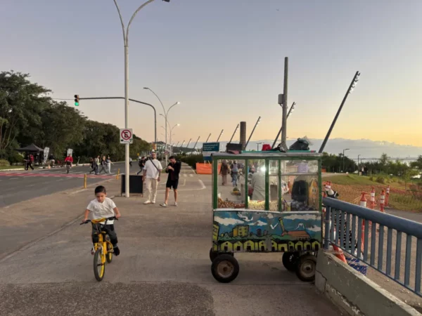 popcorn cart and kid cycling at the guiaba riverside promenade of porto alegre