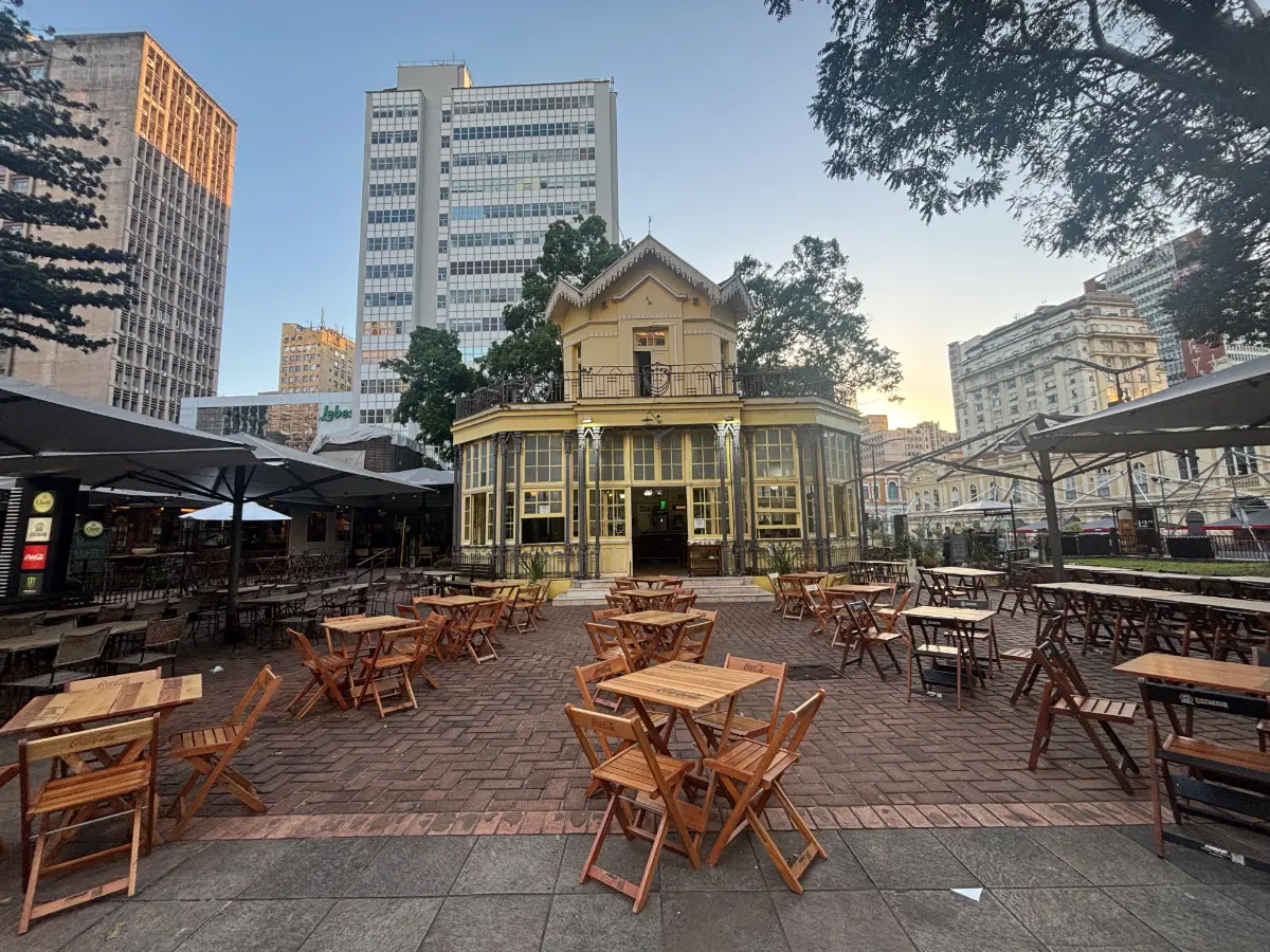 old house with tables and high-rise buildings in the background in porto alegre, brazil