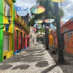 colorful umbrellas hanging over street in rocha, uruguay
