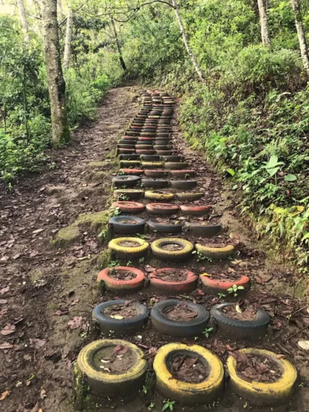 stairway made of painted car tires on trail of volcan san pedro in guatemala