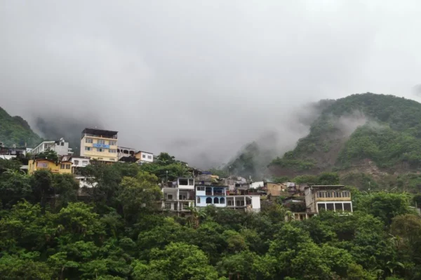 the upper village of santa cruz at lake atitlan engulfed by mist and vegetation 