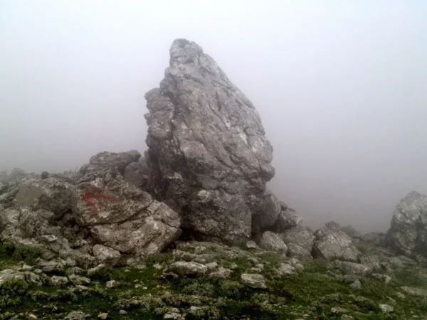 Rugged stone formations emerge from misty surroundings in Xerovouni, highlighting the area's natural beauty and mystery.