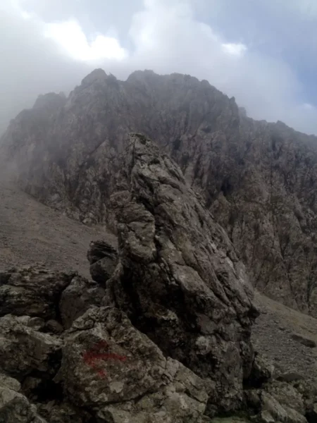 Majestic rocky landscape with towering cliffs and mist, showcasing the rugged beauty of Xerovouni mountains.