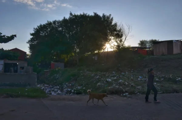 Walking by a rubbish river in la chacarita (Ricardo Brugada) shanty town in acuncion, paraguay