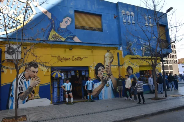 Football memorabilia shop in boca neighborhood in buenos aires with murals of maradona and messi