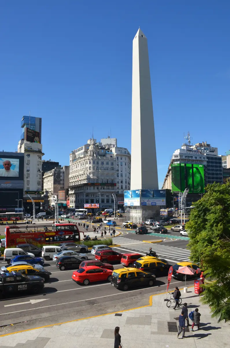The Obelisk in buenos aires and the then recently deceased Pope Francis overlooking the junction through a giant screen
